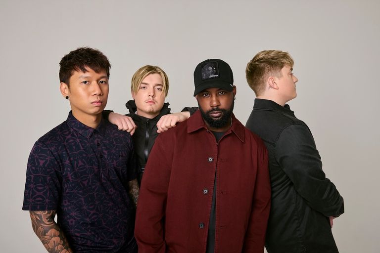 American rock band Sleep Theory four members in casual dark streetwear posing together for an official promotional band portrait against a grey studio backdrop.